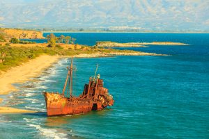 Greek coastline with the famous rusty shipwreck Dimitrios in Glyfada beach near Gytheio, Gythio Laconia Peloponnese Greece. View from distance.